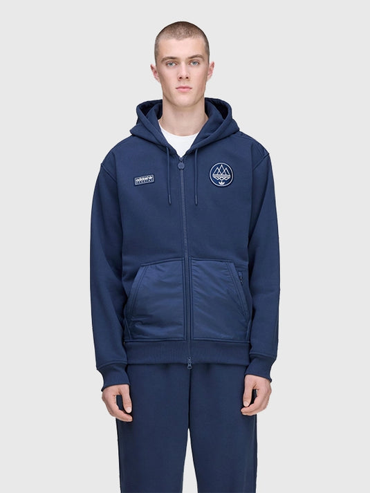Adidas Spzl Wilpshire Navy Blue Hoodie 2025 designed with a full zip closure and subtle retro detailing.