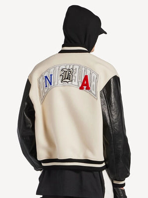 NBA x Balenciaga 2026 unisex varsity jacket with cream wool body, black leather sleeves, and high-fashion sports styling