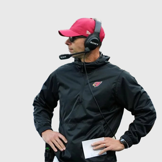 Arizona Cardinals 2025 black half-zip hooded jacket inspired by Coach Jonathan Gannon’s sideline style.
