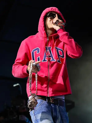 Red zip-up fleece hoodie with cap-style design from RECREATED Central Cee Coachella collection, built with cozy texture and bold urban aesthetic