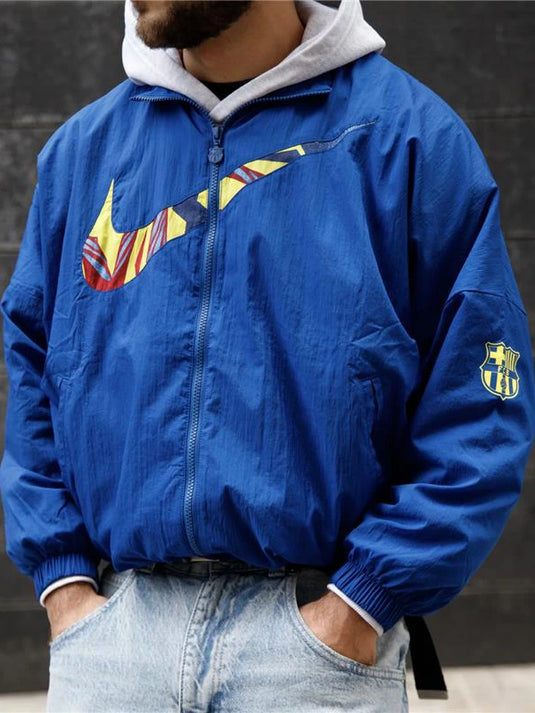 Blue Essentials jacket inspired by FC Barcelona featuring clean Nike styling and casual outerwear design