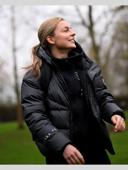 Black hooded puffer jacket inspired by Chelsea FC’s 2025 UEFA Women’s Champions League outerwear