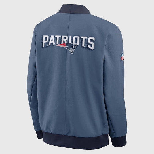 Blue sideline bomber jacket for the New England Patriots with 2025 Rivalries branding and Nike detailing.
