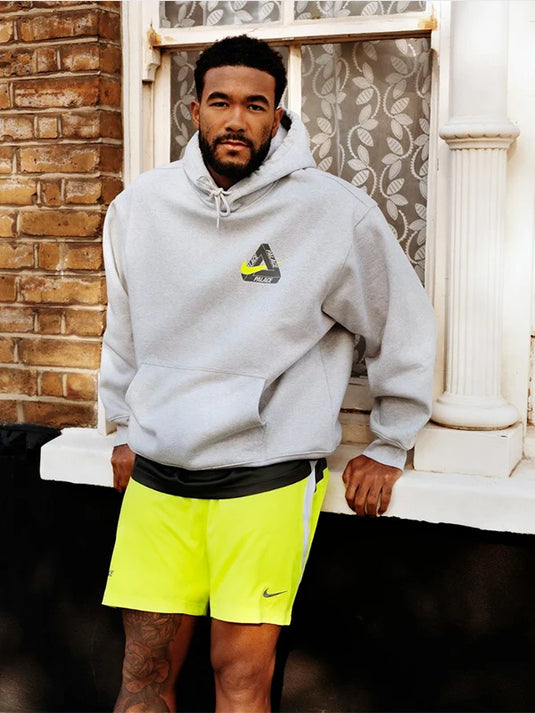 Palace x Nike Tri Swoosh pullover hoodie in light grey fleece for everyday wear and sleek co-branded appeal.
