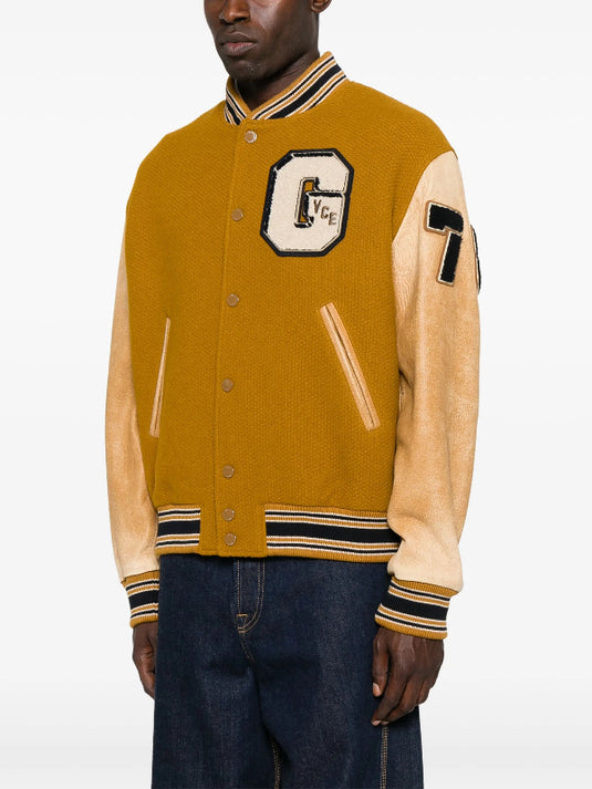 Recreated Noah Schnapp mustard varsity jacket from Stranger Things S05 Japan event.