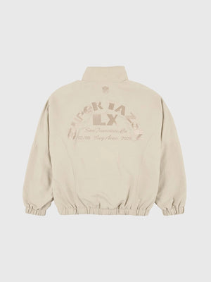 Super Tazón LX Bad Bunny off-white unisex track jacket with full zipper, side pockets, and bold event embroidery