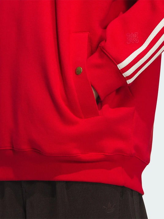 Adidas LNY SS26 recreation unisex pullover hoodie in red featuring fleece warmth and everyday wearability