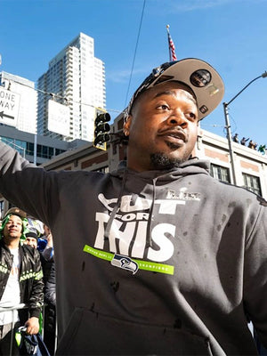 Recreated Super Bowl LX Champions Pickoff Move Parade Club pullover hoodie in mid‑tone grey with Seattle Seahawks pride design
