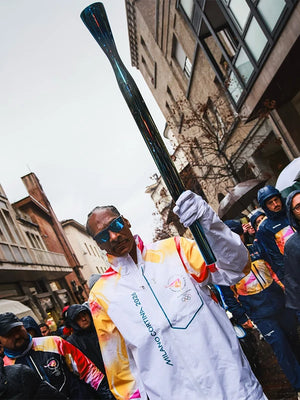 Recreated torchbearer-themed jacket in white, reflecting Snoop Dogg’s Milano Cortina 2026 Winter Olympics role, with full-zip design and smooth finish.