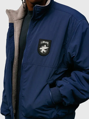Stussy 2026 unisex navy jacket crafted with smooth exterior finish and plush fleece insulation
