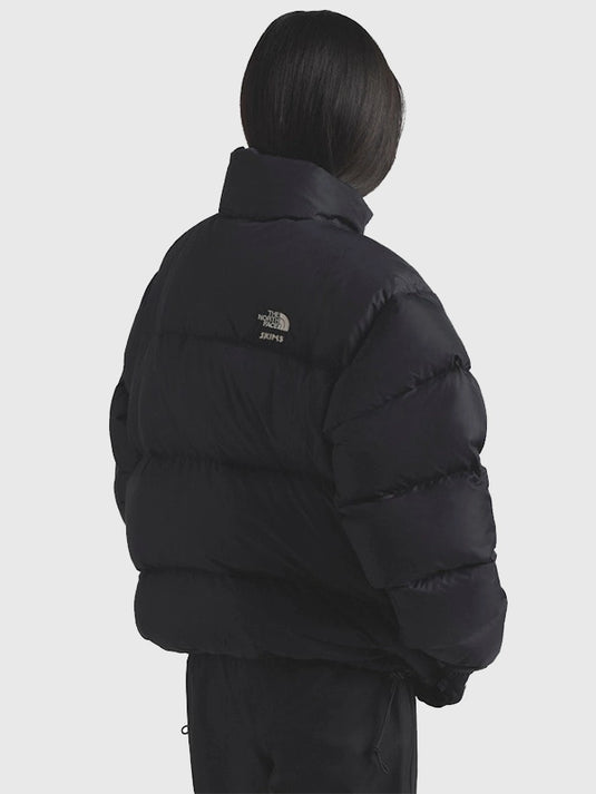 Recreated 2025 drop black Nuptse puffer jacket by The North Face × SKIMS featuring soft insulation and sleek parachute panels.
