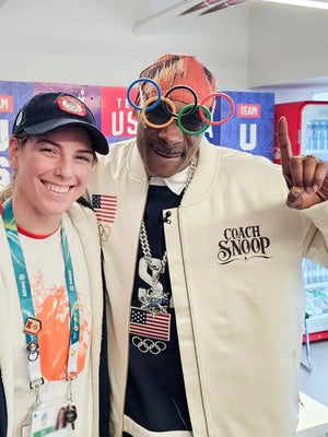 Recreated 2026 Olympic Team USA white satin bomber featuring snap button front and classic bomber silhouette