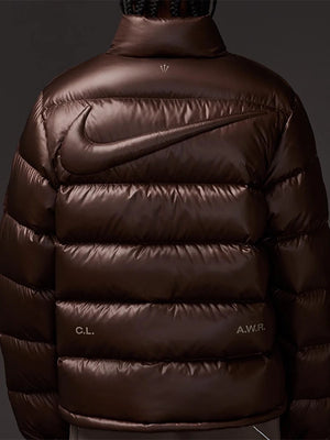 Brown 2025 Nocta x Nike Sunset jacket recreated with smooth fabric and plush puffer padding.