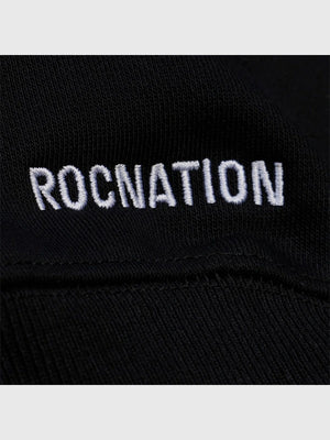 Black Roc Nation x Paper Planes Super Bowl LX 2026 fleece pullover hoodie recreated with relaxed fit and streetwear–centered graphic design.