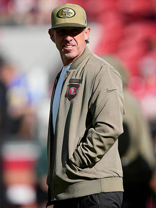 San Francisco 49ers 2025 Salute to Service olive green cotton bomber jacket with subtle team graphics and patch details.