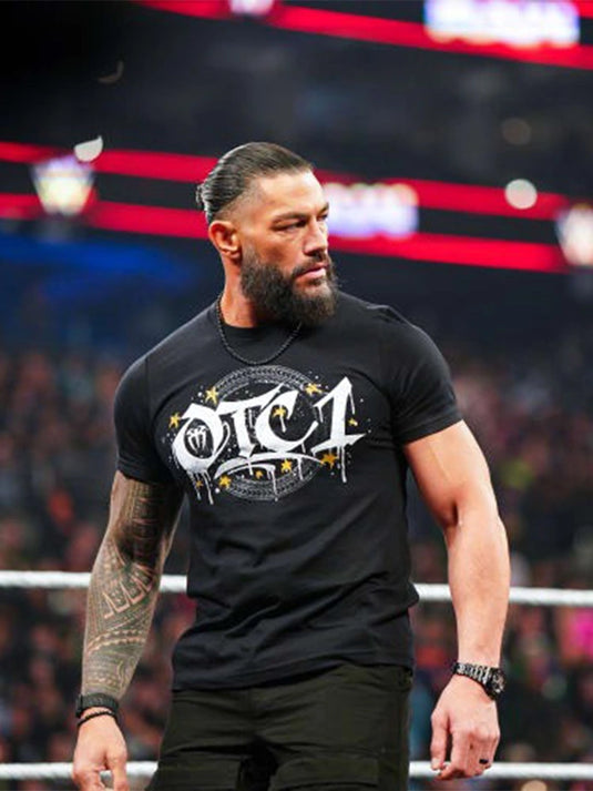 Black crewneck t-shirt recreated from WWE RAW 2026, featuring a Roman Reigns OTC-1 gold graphic printed on soft cotton fabric.
