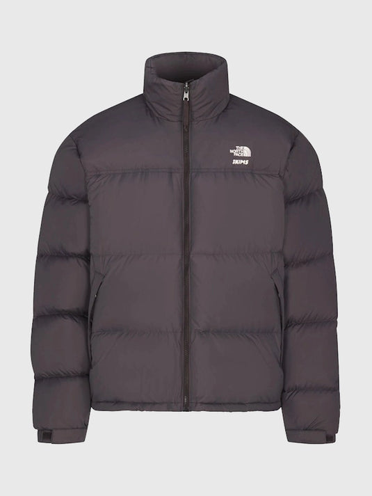 Recreated 1996 Nuptse brown parachute puffer jacket from The North Face × SKIMS with soft, weather-ready insulation.