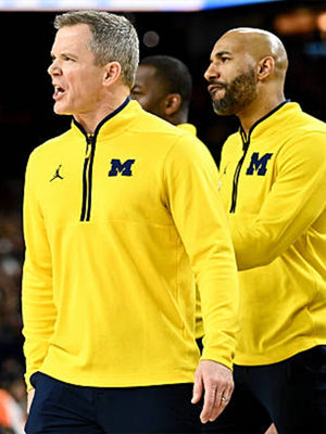 Recreated Michigan Wolverines Coach Dusty May Victory yellow quarter-zip pullover jacket with smooth texture and clean athletic finish