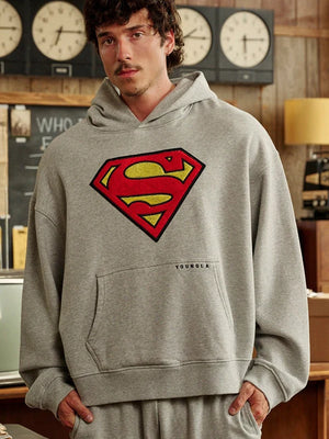 Grey oversized fleece hoodie combining Youngla streetwear style with Superman Legacy inspiration