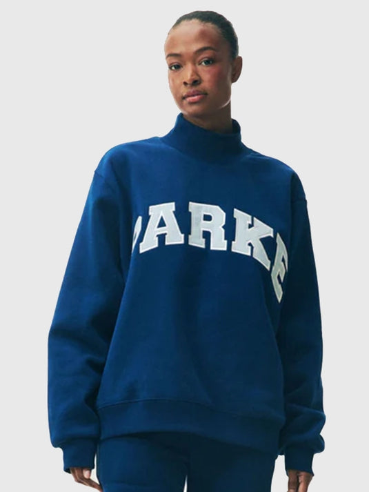 Blue fleece turtleneck sweatshirt recreated from the 2025 Parke Holiday Varsity collection with minimal, refined detailing.