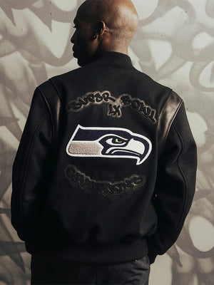 Black Fanatics x APEXER full‑snap artisan jacket celebrating the Seahawks’ Super Bowl LX championship with embroidered chenille graphics