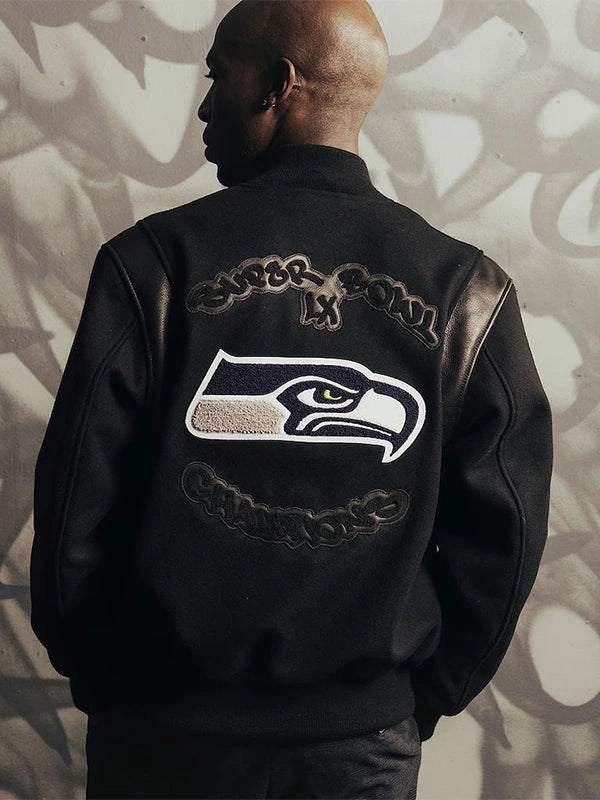 Black Fanatics x APEXER full‑snap artisan jacket celebrating the Seahawks’ Super Bowl LX championship with embroidered chenille graphics