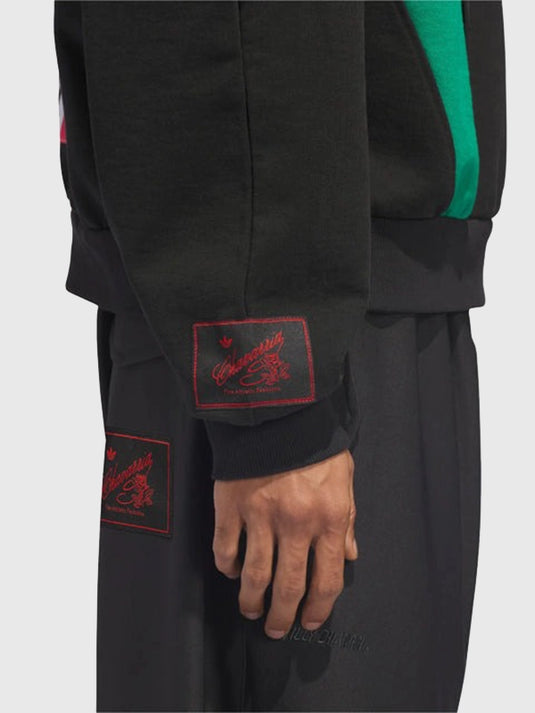 Recreation of the Adidas x Willy Chavarria Chicano 2025 black women’s oversized crew-neck offering a relaxed and stylish silhouette