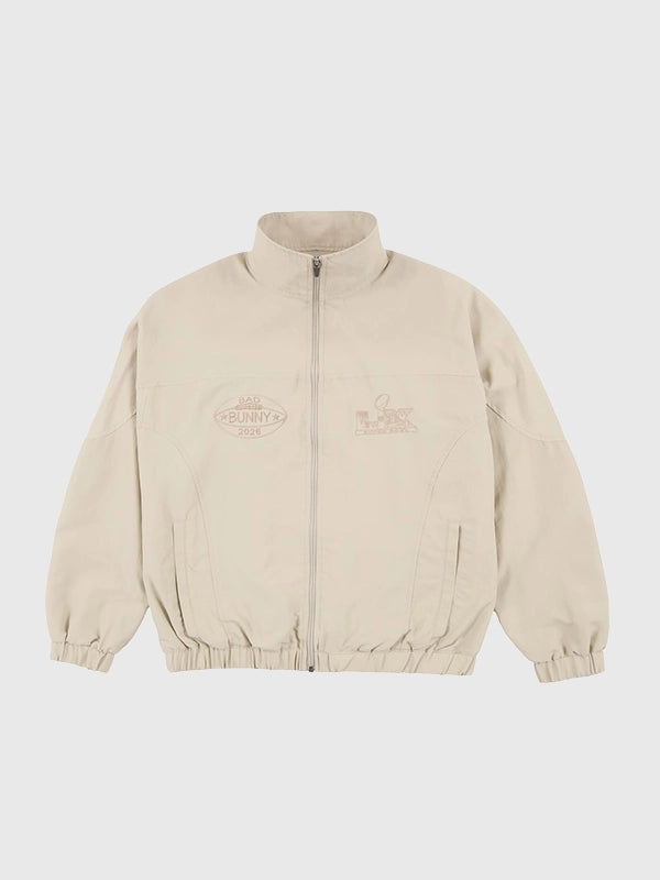 Off-white Bad Bunny x Super Tazón LX full-zip track jacket featuring monochromatic NFL-inspired designs and elastic cuffs