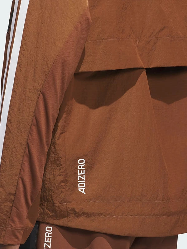 RECREATED Brown Adidas x Pharrell Williams Humanrace Adizero Archive 2026 Jacket combining smooth technical fabric with a dynamic sporty profile