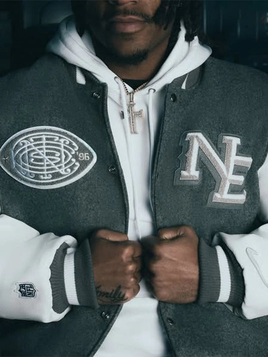 Recreated CNCPTS x Nike x Patriots 2025 Rivalries wool varsity jacket in grey and white with set-in sleeves.