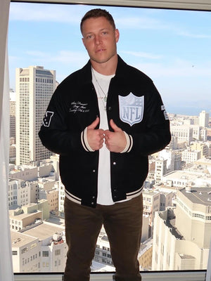 Black wool varsity jacket recreated from the Abercrombie 2026 Pro Bowl Games collection, inspired by Christian McCaffrey and finished with leather sleeves.