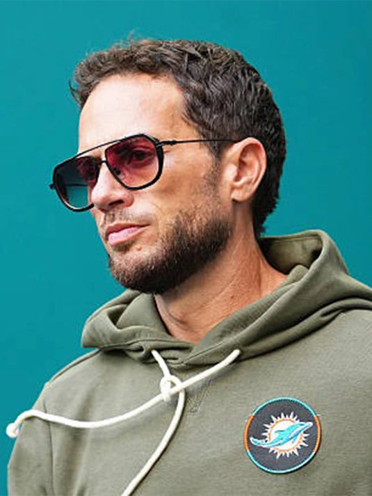 Miami Dolphins 2025 Salute to Service olive green hoodie modeled after Coach Mike McDaniel’s sideline look.