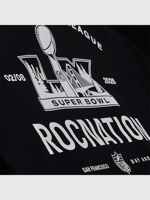 Black fleece pullover hoodie recreated from the Roc Nation x Paper Planes 2026 Super Bowl LX drop with structured fit and standout branding.