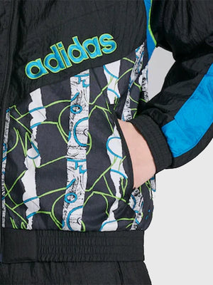 Manchester United x Adidas Track Jacket featuring 90/92 season inspiration, ribbed trims, and timeless sporty appeal