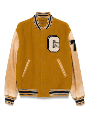 Mustard-colored varsity jacket modeled after Noah Schnapp’s Japan promotion appearance.