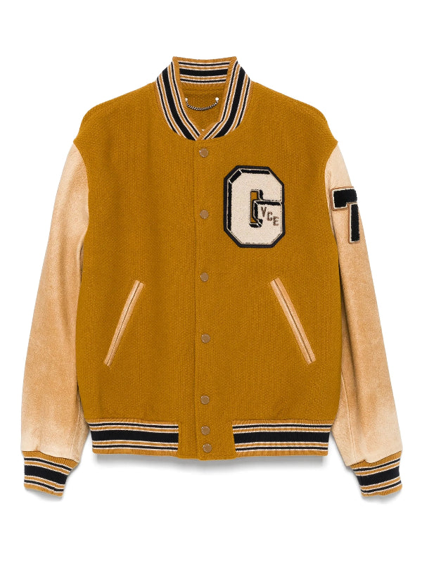 Mustard-colored varsity jacket modeled after Noah Schnapp’s Japan promotion appearance.