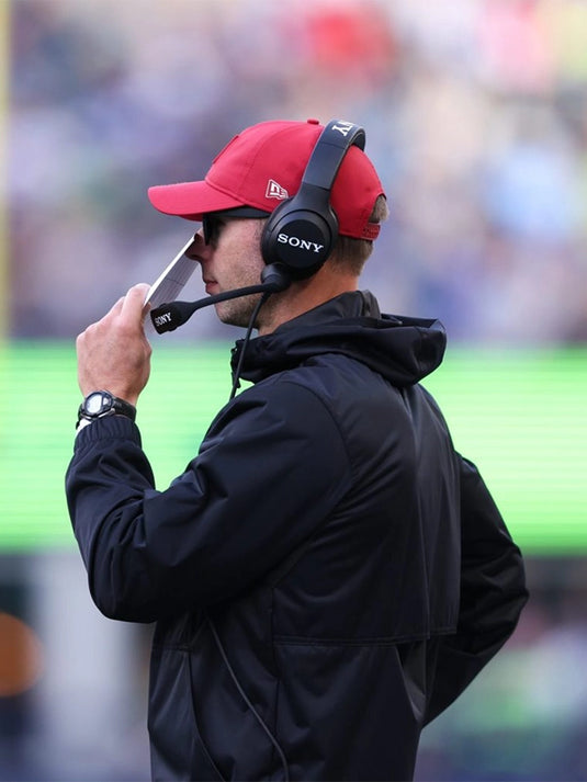 Jonathan Gannon Cardinals vs Seahawks 2025 black hooded jacket featuring half-zip closure and team graphics.