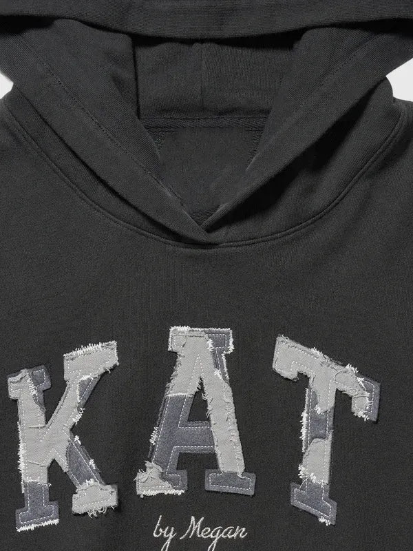 RECREATED Kat by Megan pullover hoodie in black, styled with cropped length, lace-up sleeve accents, and soft fleece construction
