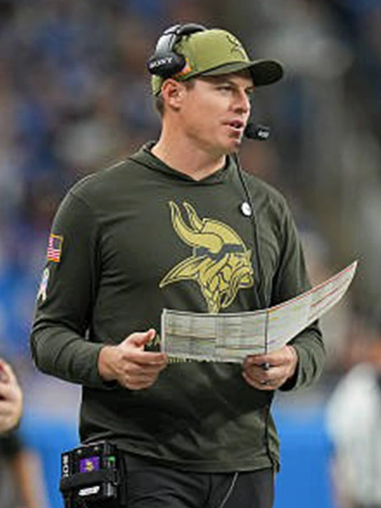 Kevin O’Connell Vikings vs Lions Olive Green Hoodie T-Shirt showcasing subtle Salute to Service design.