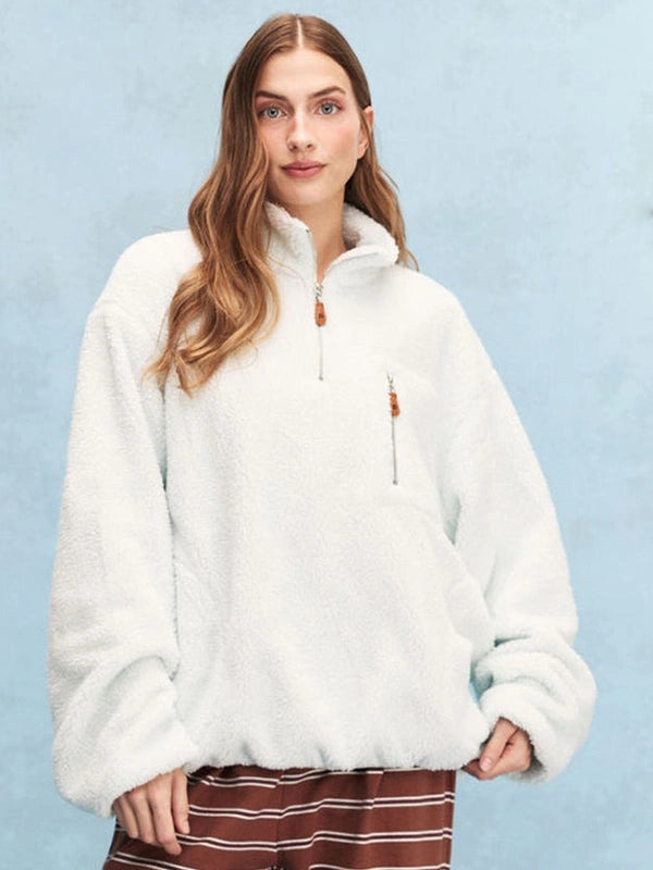 Light blue Parke 2026 quarter zip sweatshirt crafted in soft fleece, featuring a relaxed fit and minimalist design
