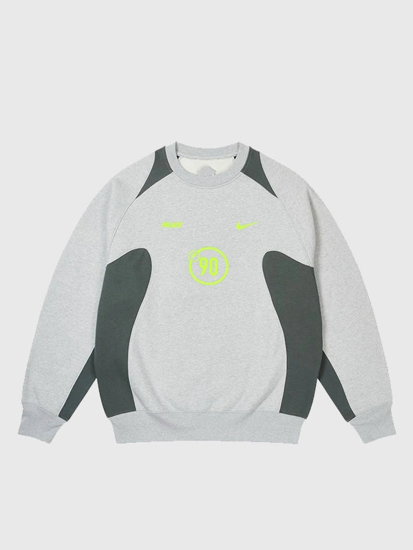 Palace x Nike 2025 Total P90 Crew Sweatshirt in soft light grey fleece featuring the iconic dual logo design.