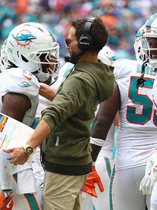 Miami Dolphins Salute to Service 2025 olive hoodie crafted in warm fleece with subtle logo and sleeve patch accents.