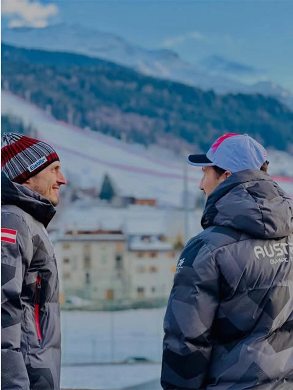 Team Austria grey hooded jacket inspired by Milano Cortina 2026 Winter Olympics ski jumping event, full zip front and performance fit