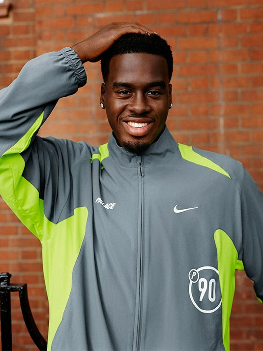 Palace x Nike 2025 Total P90 grey full zip track jacket with sporty minimalist design.