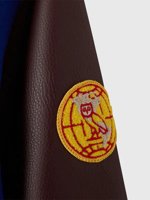 RECREATED OVO Harlem Globetrotters Blue & Brown Varsity Jacket featuring premium wool body, leather sleeves, and a clean athletic profile