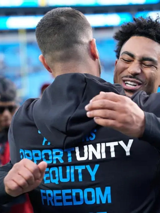 Nike black Inspire Change 2025 sideline pullover hoodie for the Carolina Panthers with Opportunity Equity Freedom Justice messaging