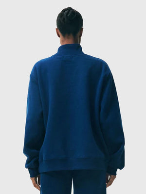 Recreated blue fleece turtleneck from the 2025 Parke Holiday Varsity range showcasing clean construction and warm fabric.