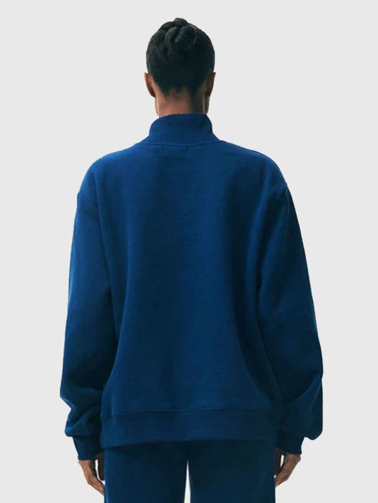Recreated blue fleece turtleneck from the 2025 Parke Holiday Varsity range showcasing clean construction and warm fabric.