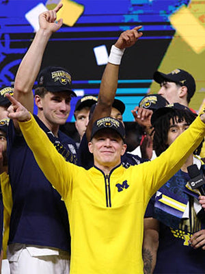 Recreated yellow Michigan Wolverines Coach Dusty May quarter-zip jacket with comfortable fit and refined sportswear look