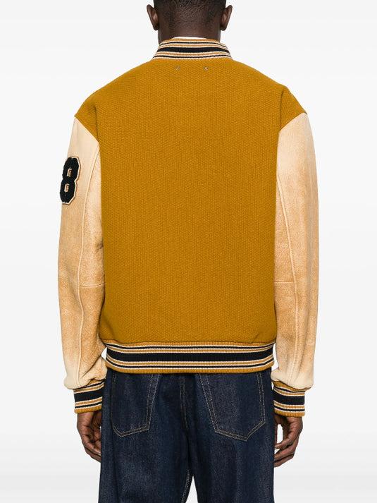 Stranger Things S05 mustard varsity jacket recreation reflecting Noah Schnapp’s promo style.